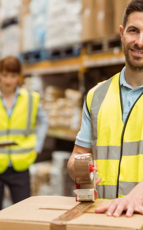 Smiling,Warehouse,Workers,Preparing,A,Shipment,In,A,Large,Warehouse
